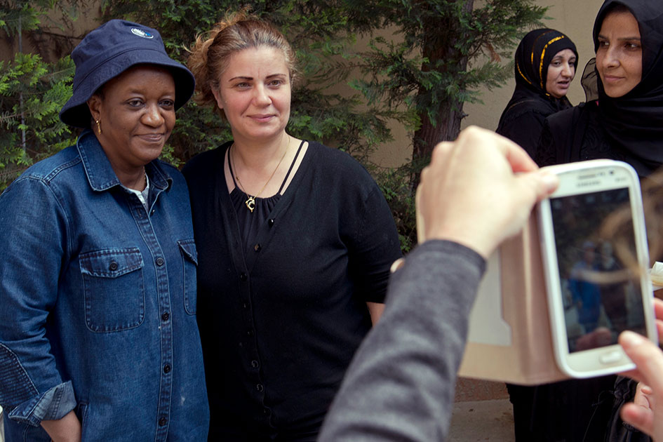 Zainab Bangura posing for a photo with a Syrian refugee woman.