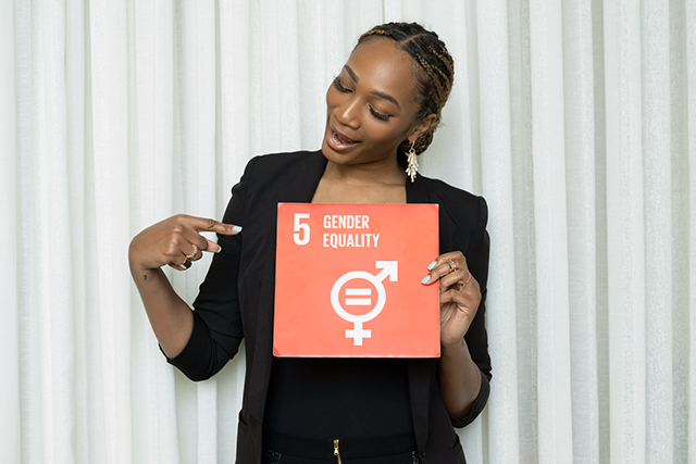 A girl grabbing a box with the SDG about gender equality