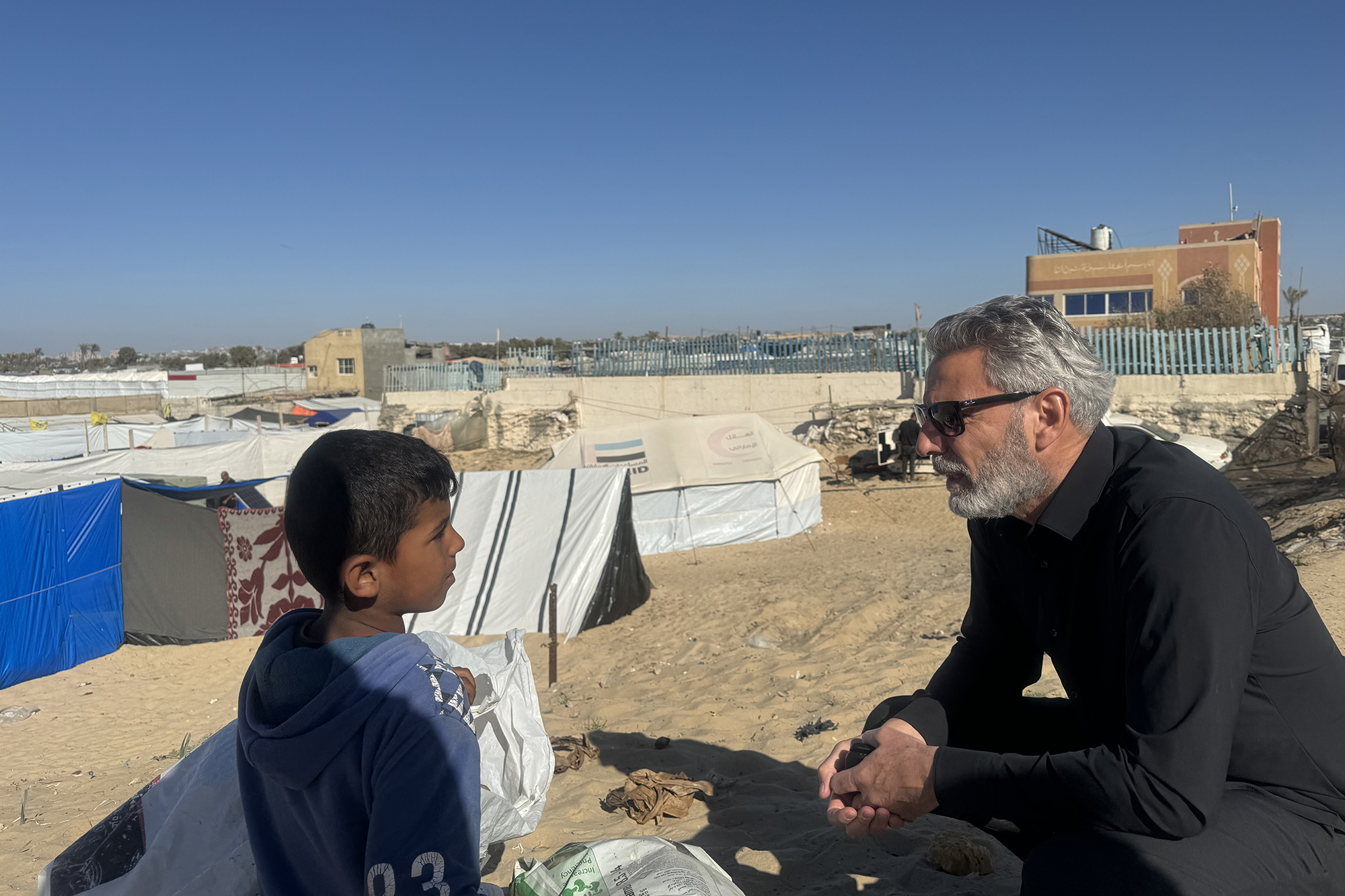 Muhannad Hadi talking to a young boy