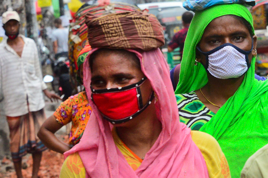 women and men with masks on the street