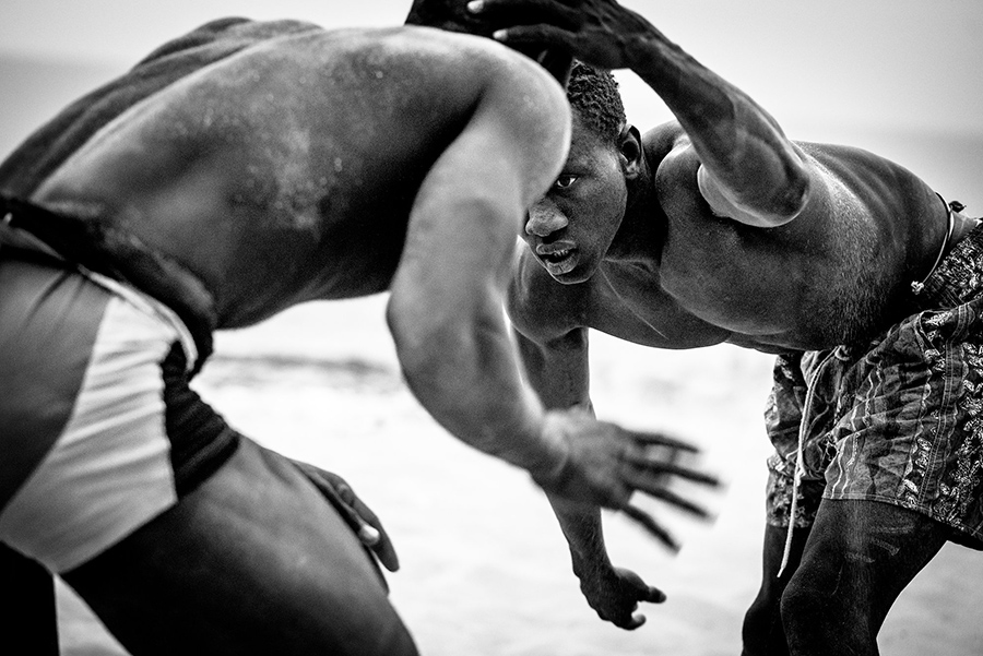 Two young men practicing wrestling.