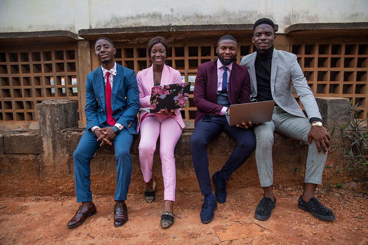 four young people with business outfits