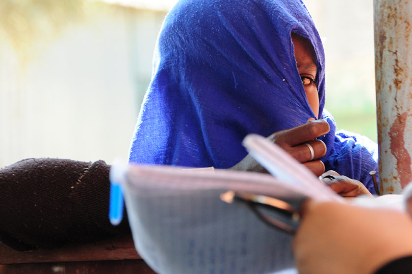 young woman covering her face