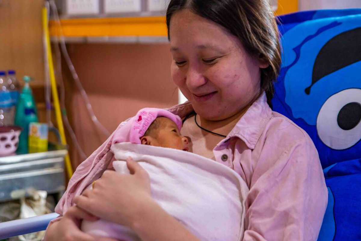 A woman holds her newborn