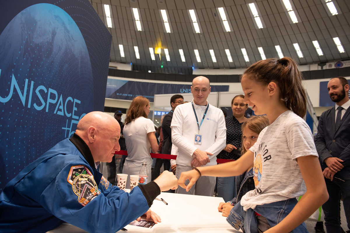 A girl fist-bumping an staff