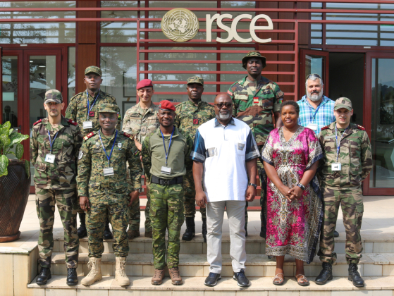 group photo of men and women at the doorstep of the entry to a grand building