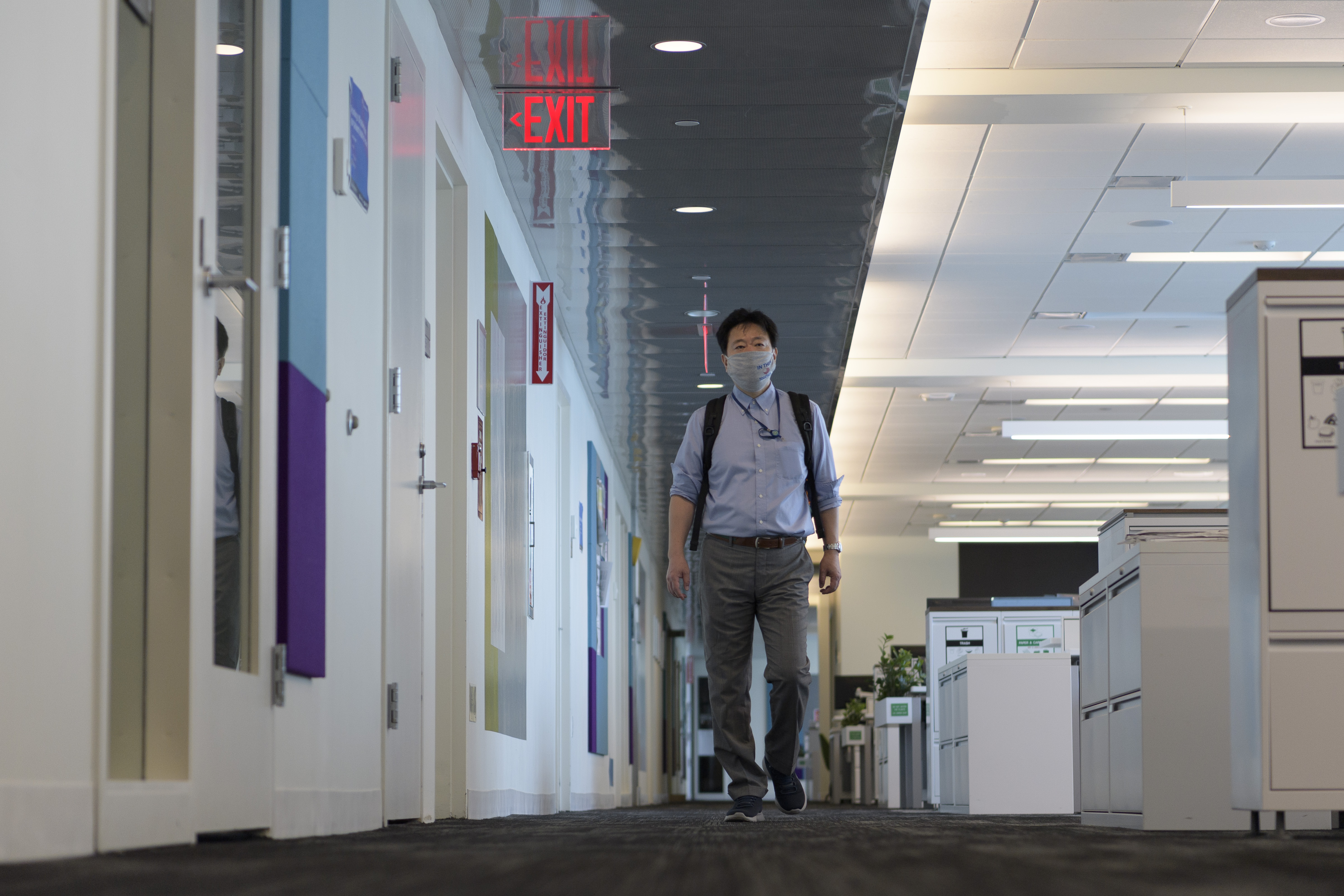 Man walks through an open space office.