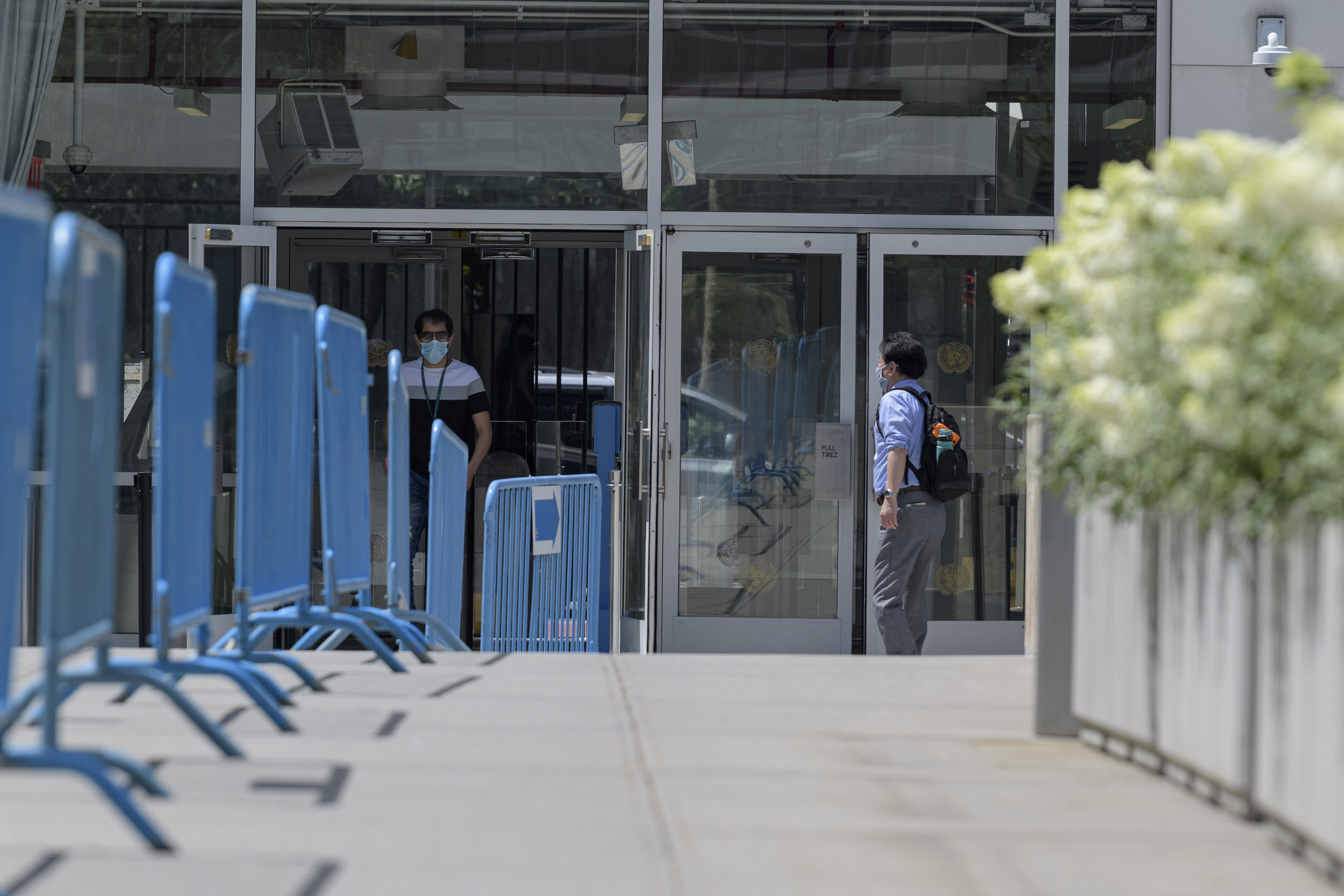 Man stands in front of UN Secretariat entrance.