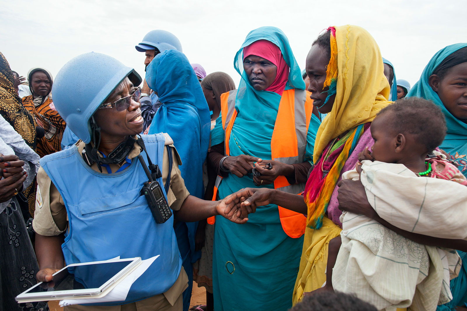 A police officer heling a group of women