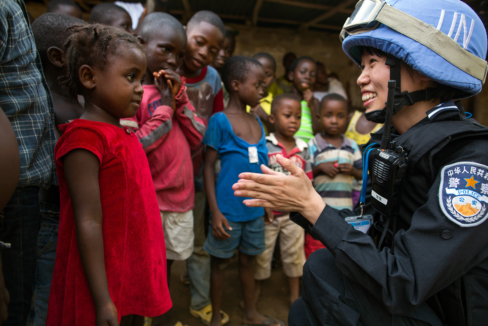 A Chinese police officer talking to small kids