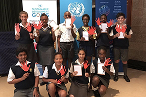 South African students hold red hands to symbolize the end of slavery (UNIC Pretoria) 