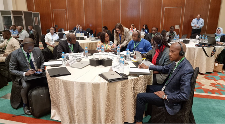 people seated in a hall at round tables