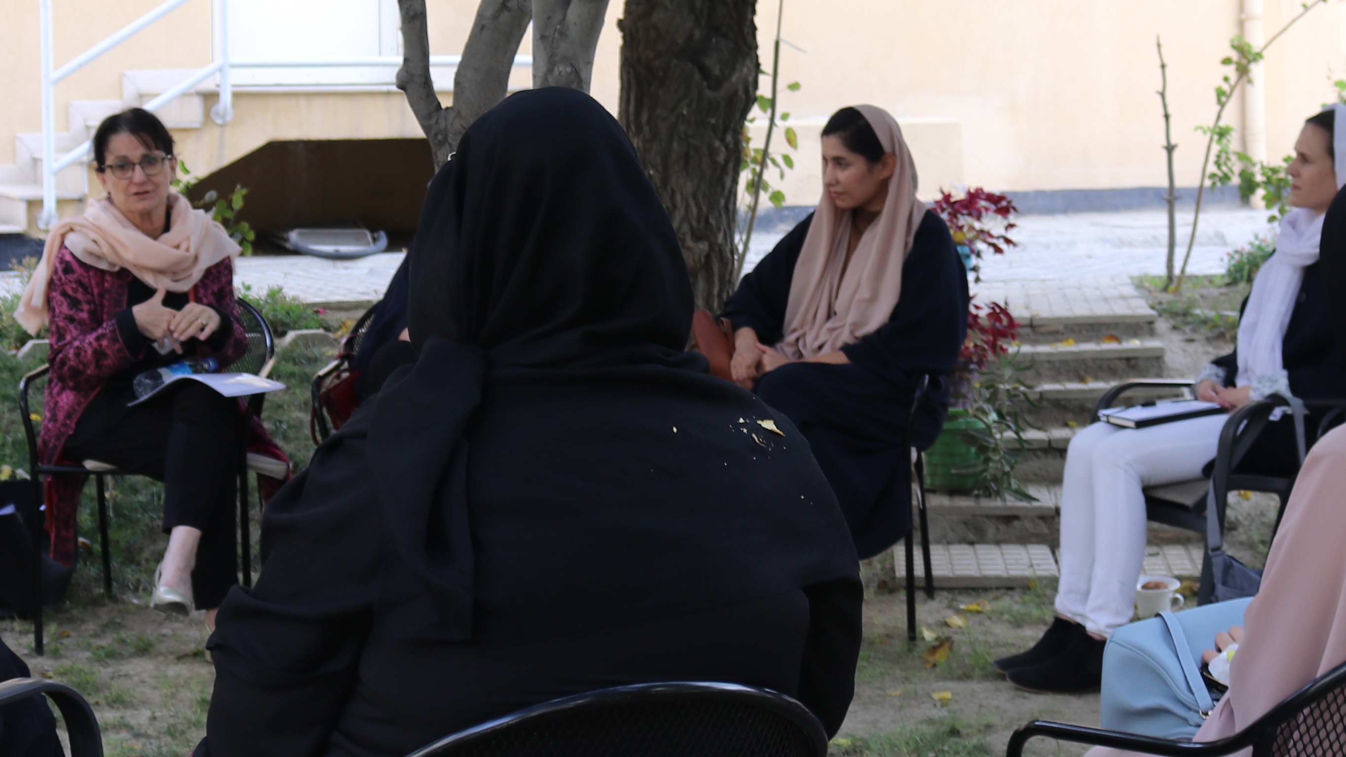 closeup of the photo of Deborah Lyons, having an informal meeting with female Afghan colleagues