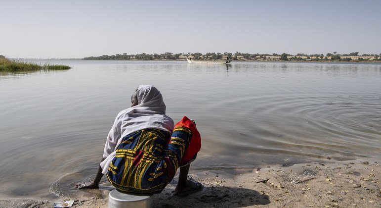 une femme assise au bord de l'eau