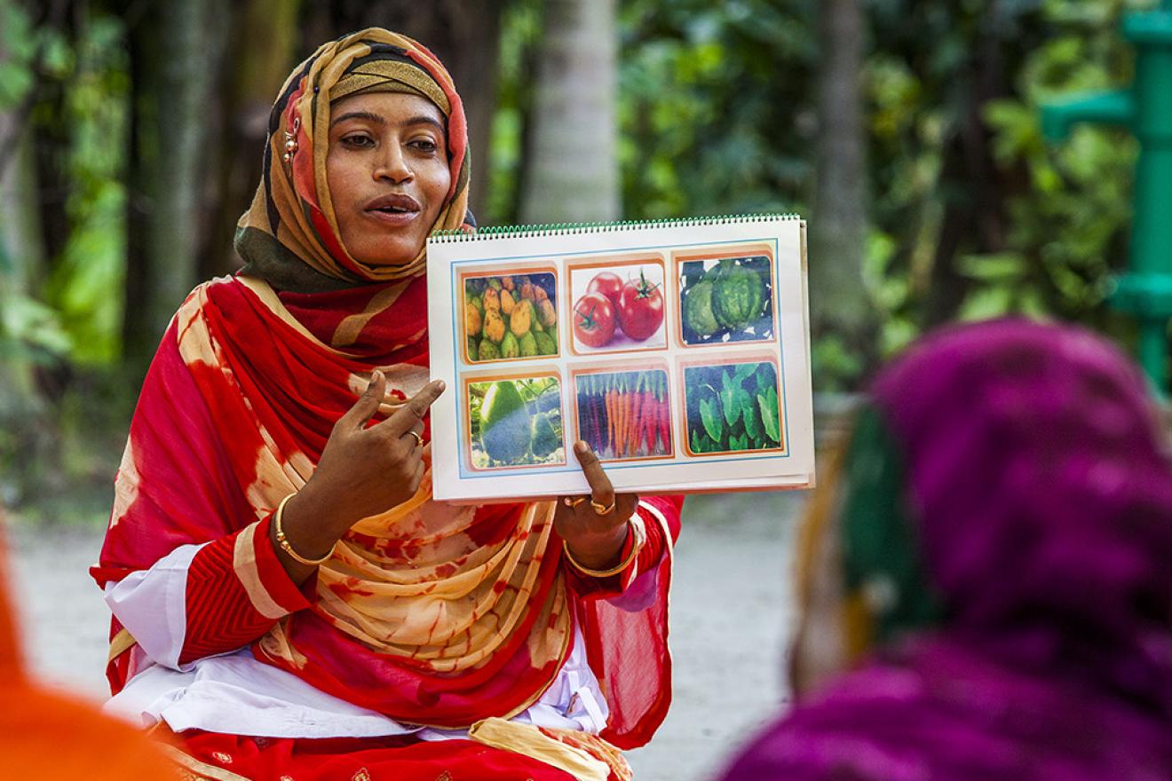 Woman pointing to food training materials 