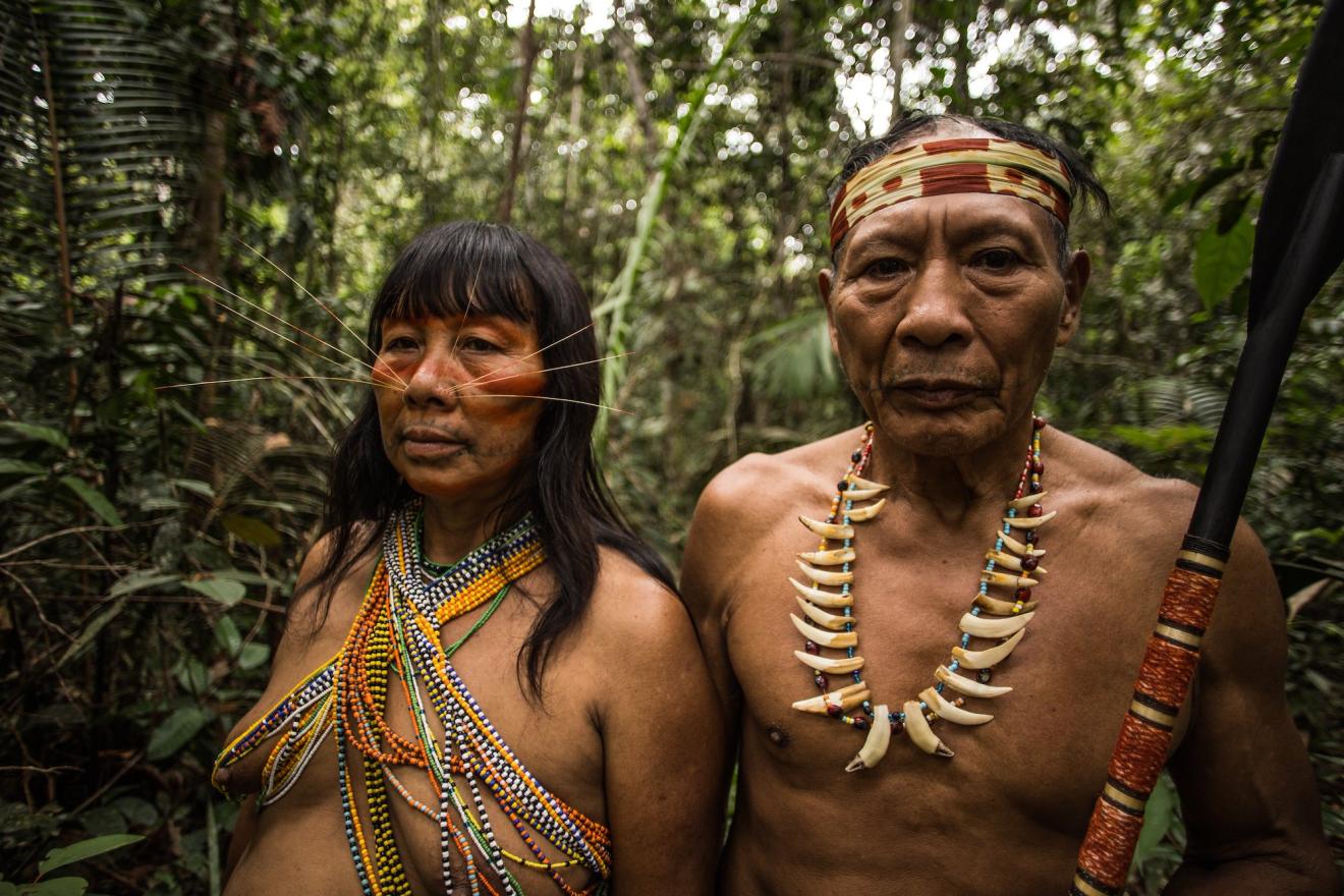 Matse woman and man pose for the camera in the Peruvian Amazon.