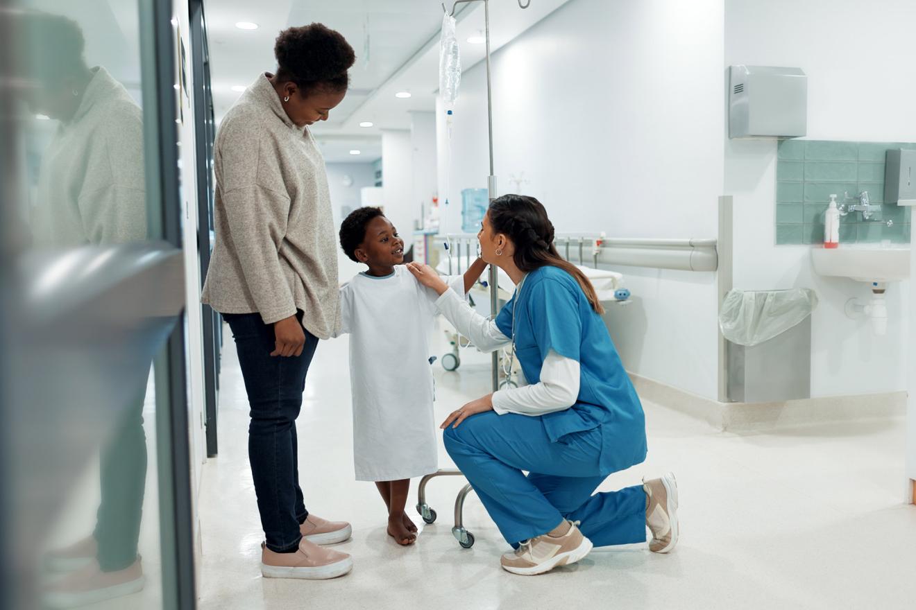 child with health worker and parent in hospital