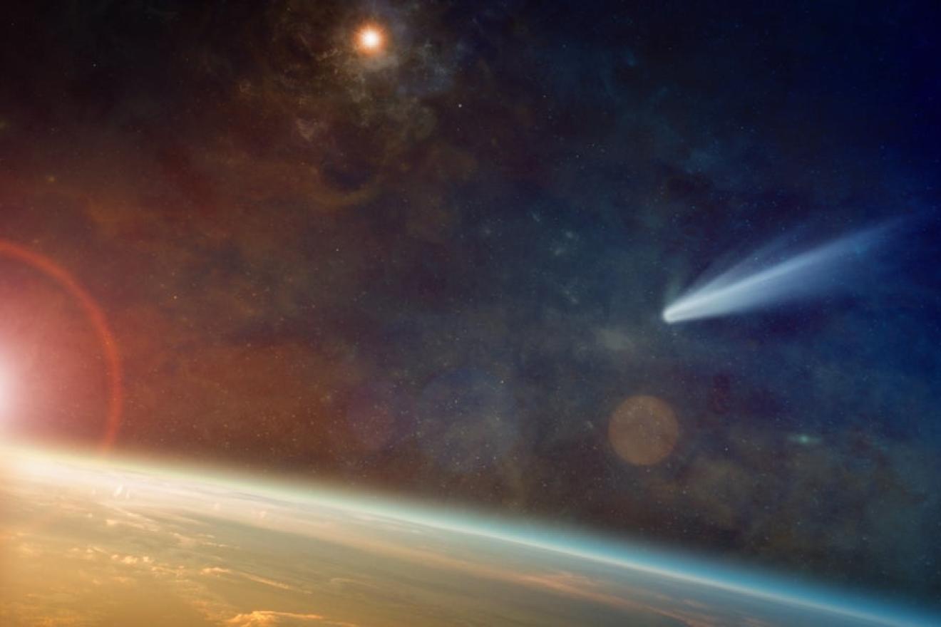 A digital image of the earth seen from space. To the left the sun breaks over the horizon, while a comet crosses the sky above.