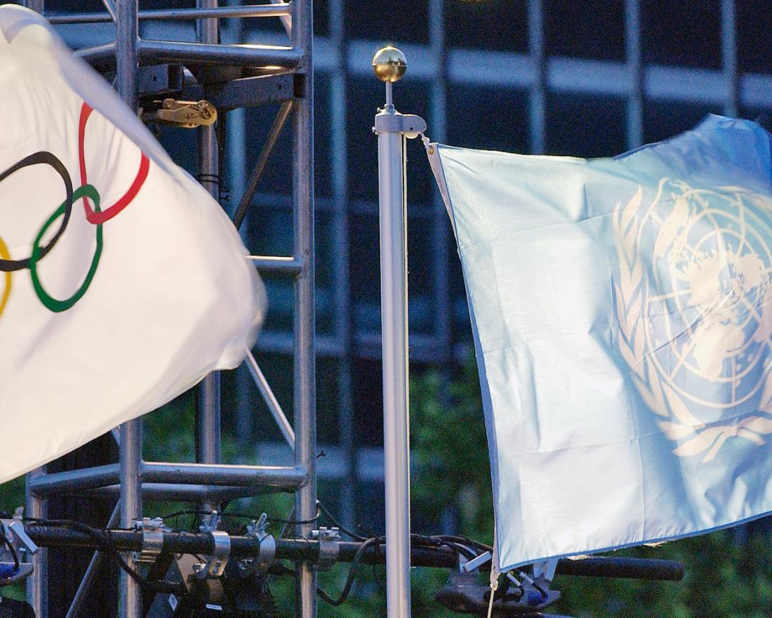 The United Nations and the Olympic flags are raised at the UN Headquarters. 