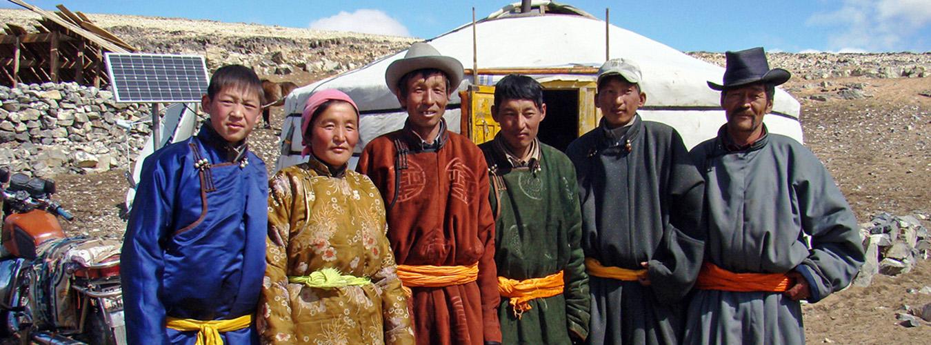 A family in rural Mongolia in front of their ger.