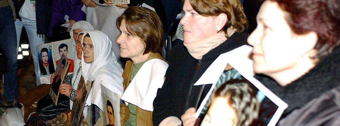 Relatives of the missing holding their photos