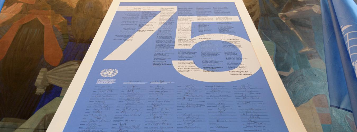 Poster with the numbers 75 and many signatures.