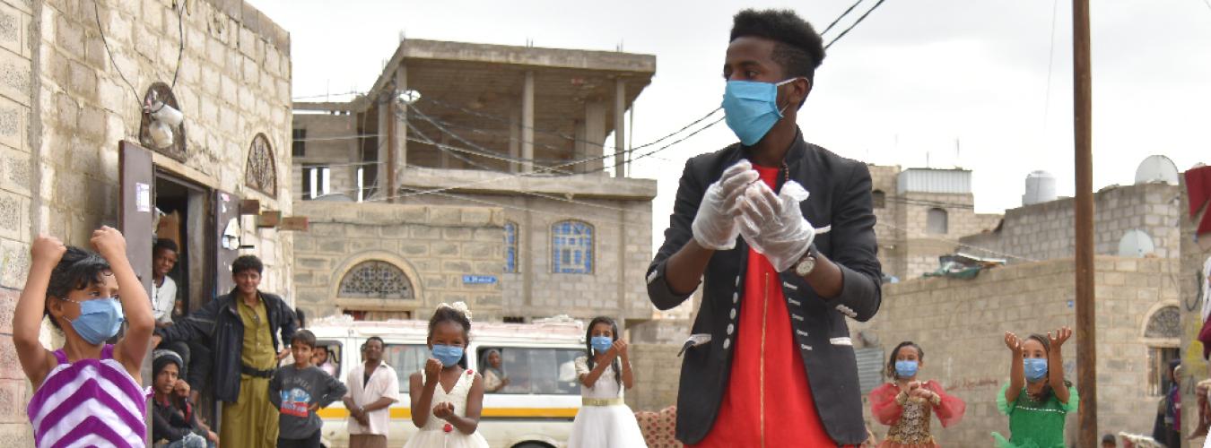 Rauf Salem, a volunteer, instructs children on the right way to wash their hands