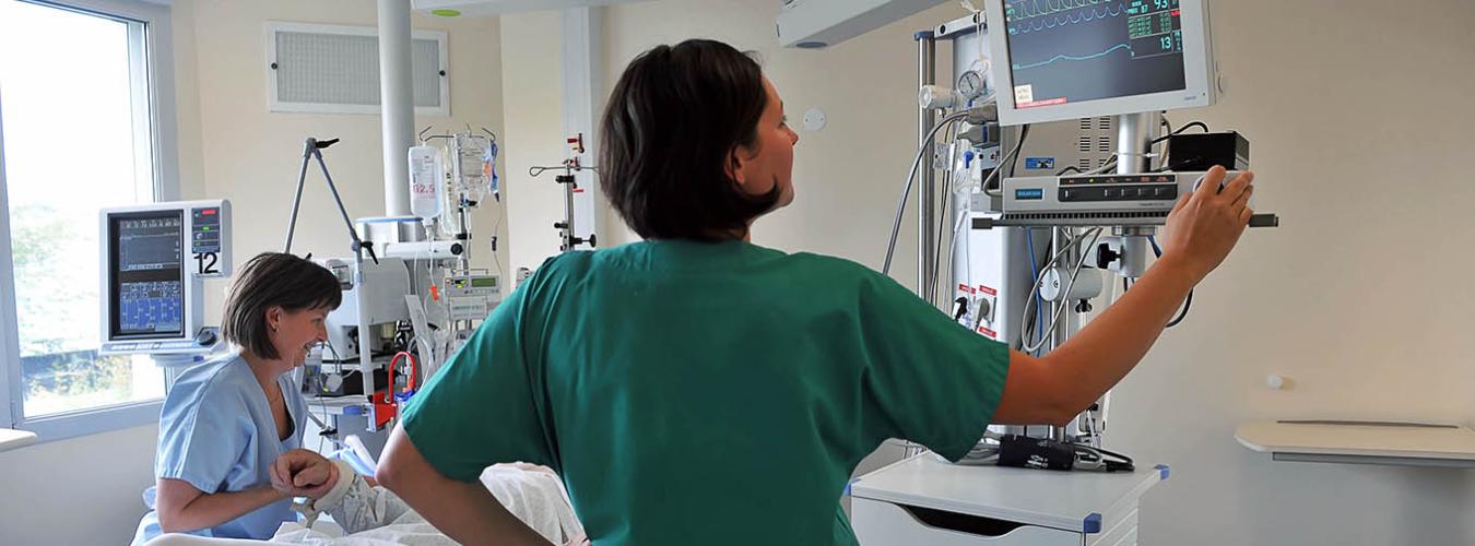 female staff with patient in ICU