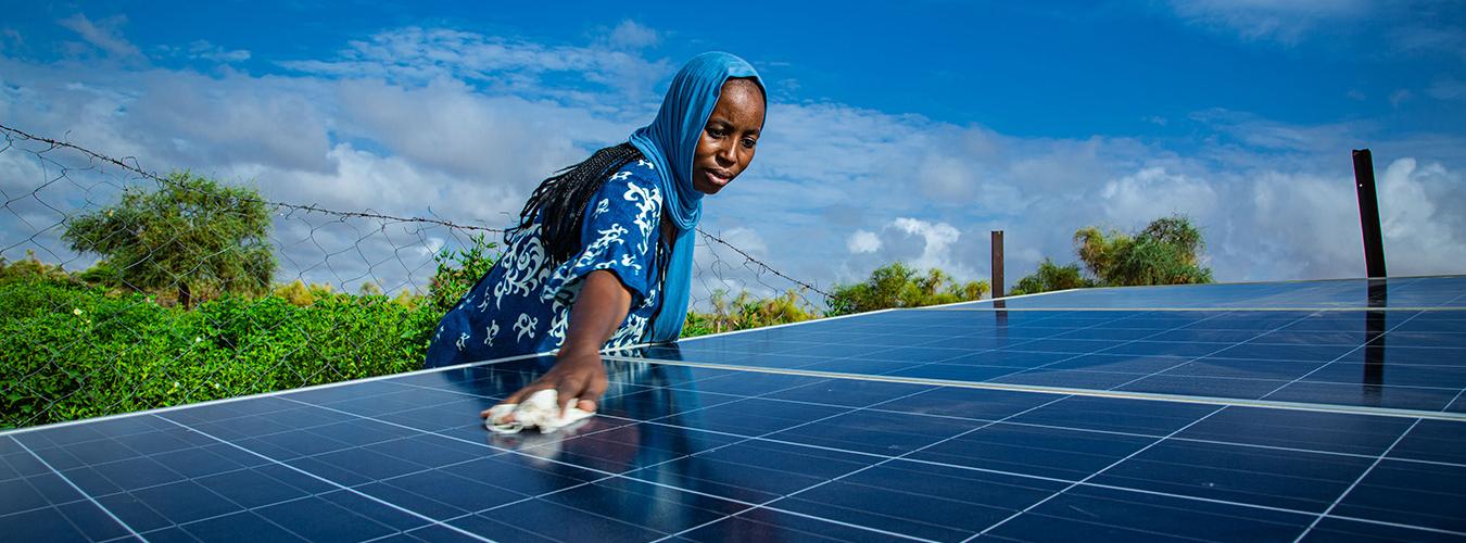 Woman cleaning a solar panel