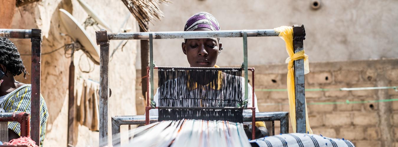 woman working on loom