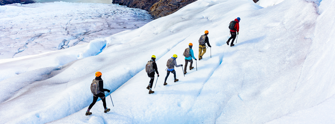 Hikers walking on a glacier