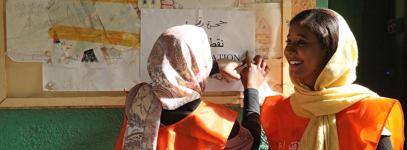 two young women poll workers