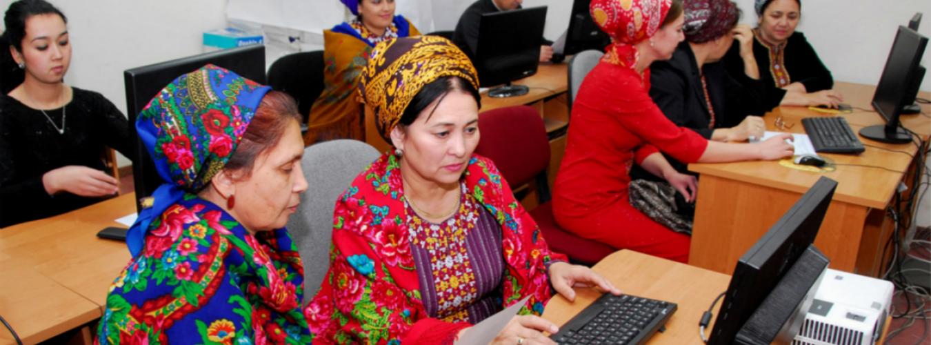 Women looking at computers in groups