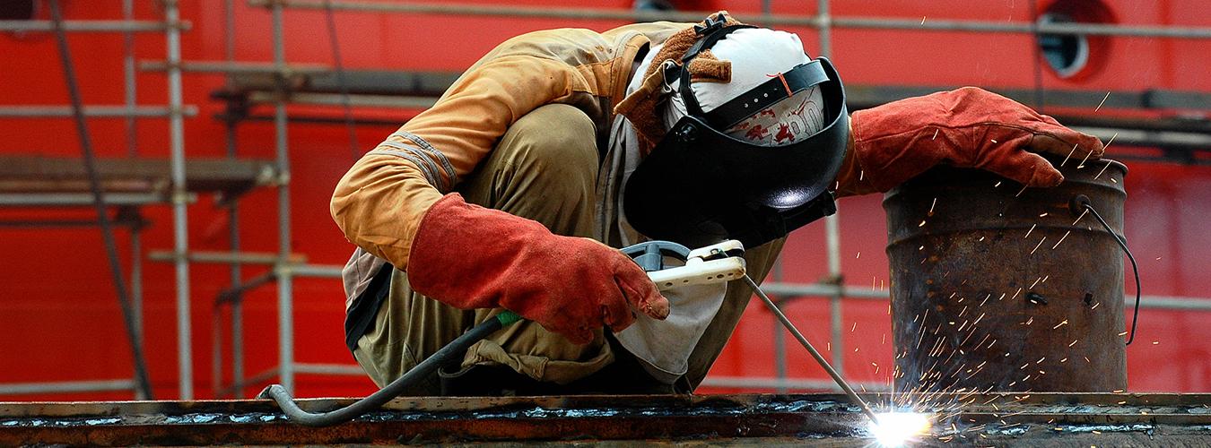 A shipyard worker engaged in the welding process