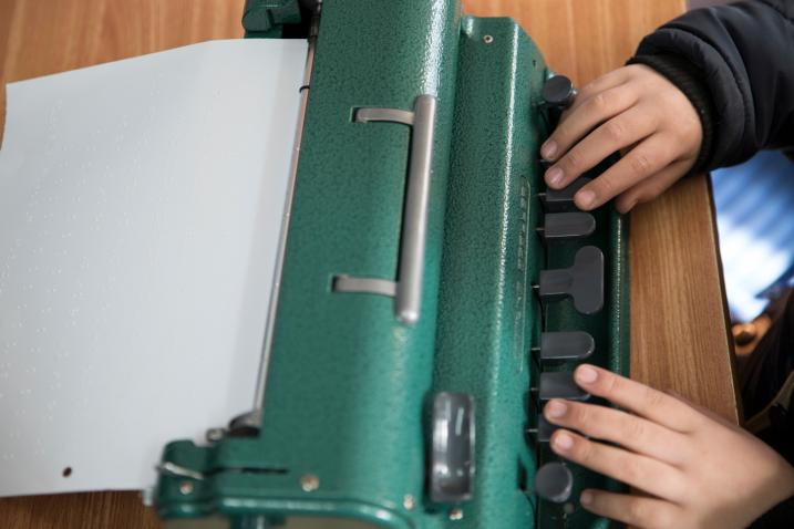 7-year-old Jihad Atrash, who is blind, uses a Braille device in class.