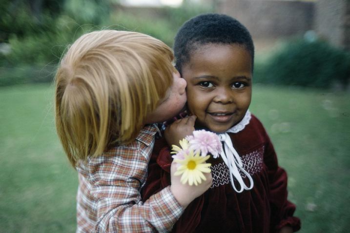 Children share a kiss.