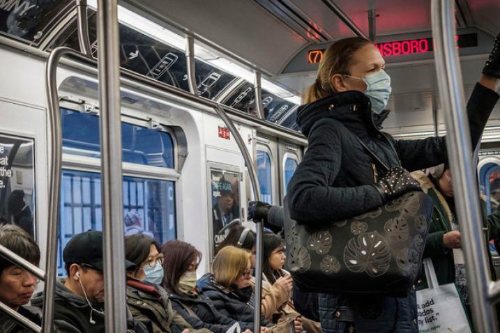 people with face masks on subway