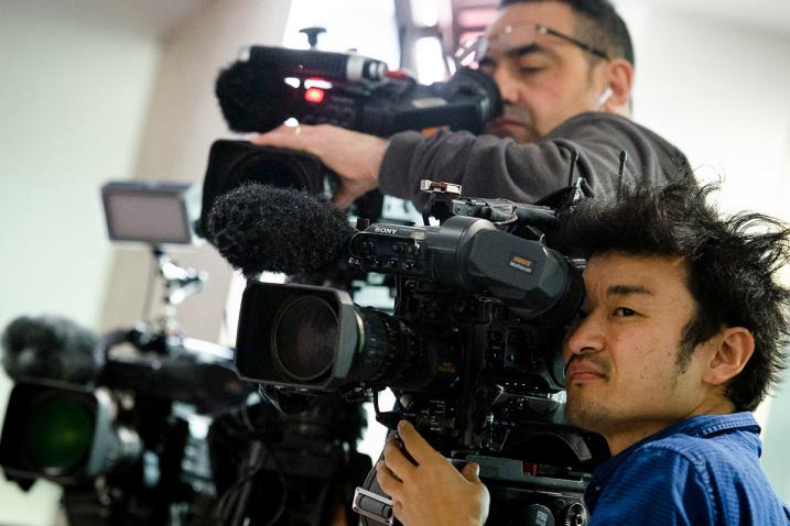 Two journalists videotaping a press encounter.