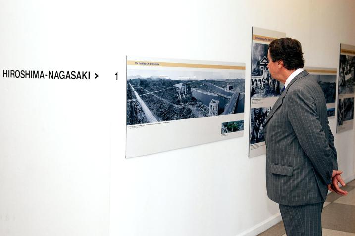 A man examines photographs at the opening of exhibition "Against Nuclear Arms."