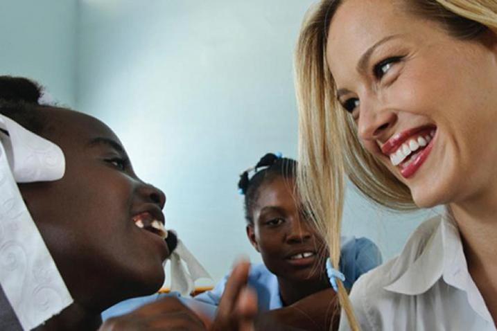 Petra Nemkova facing a girl as both smile. 