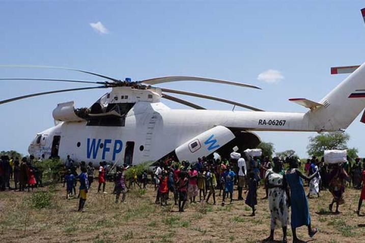 A WFP helicopter surrounded by a crowd in southern Sudan.