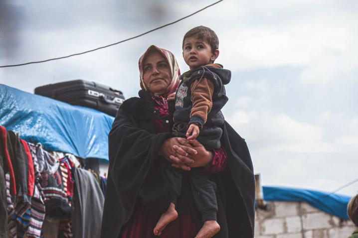 A widow holds her grandson in a displaced persons camp in northern Idlib Governorate, Syria.