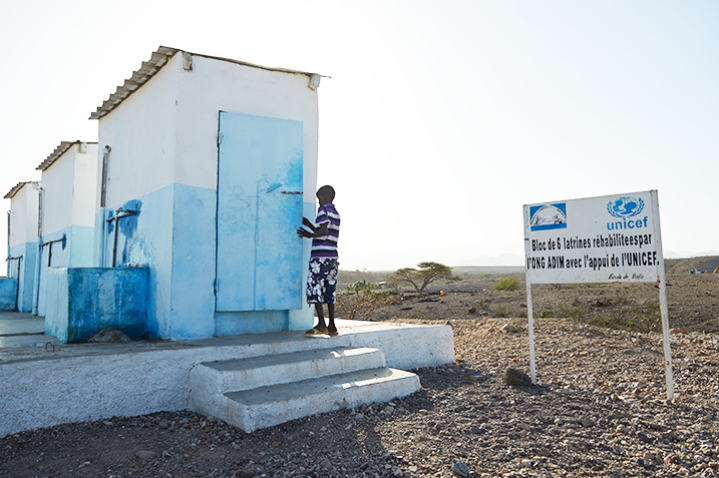 A young boy about to use a sanitary latrine