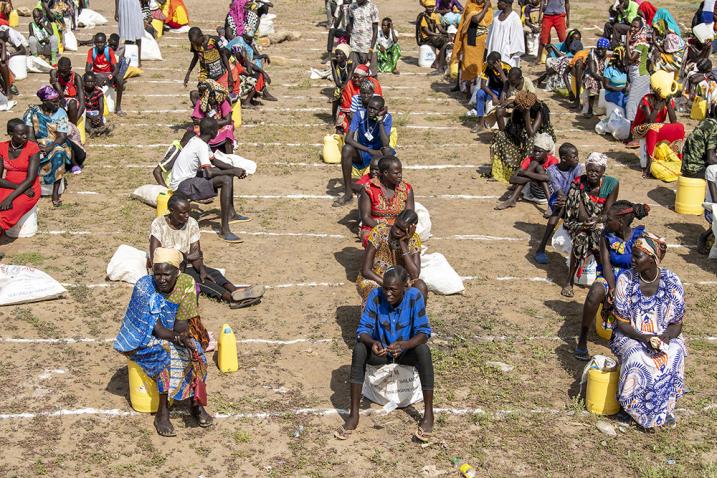 South Sudanese refugees practice social distancing as they wait to access a food distribution at Kakuma camp. 