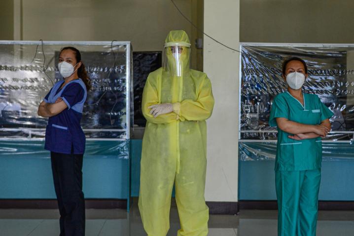 Wearing a full protective suit, a women doctor who leads a group of volunteer medical professionals attending to COVID-19 patients and persons under investigation at a community hospital in the Philippines.