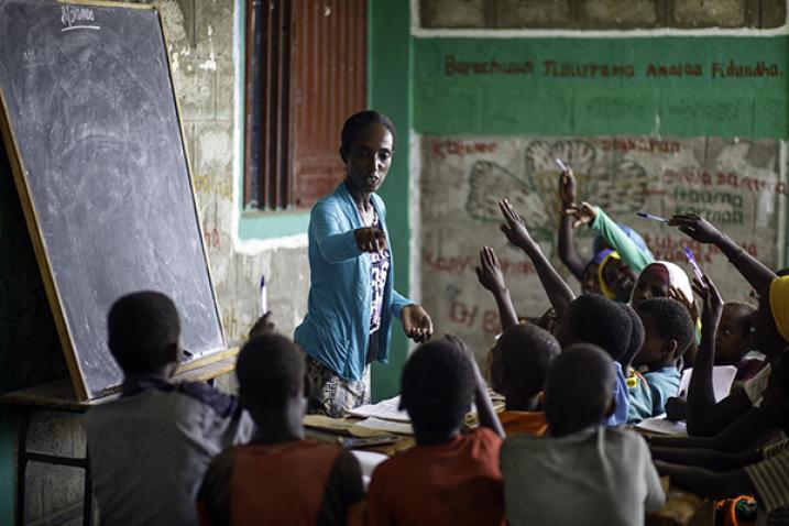 A teacher in Ethiopia conducts her class outside due to a lack of classrooms.