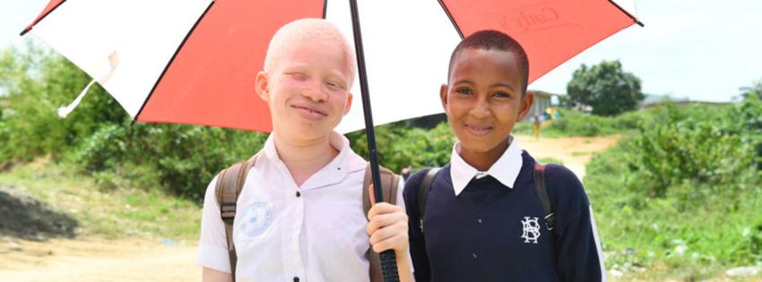 12-year-old girl from Côte d'Ivoire with albinism, with her friend.