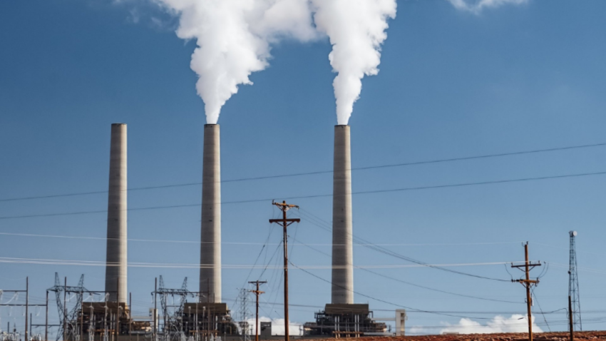 Industrial chimneys with smoke causing air pollution.