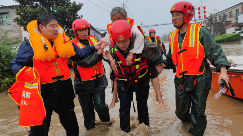 Emergency workers rescue an elderly person in Xuchang, in China's Henan Province.