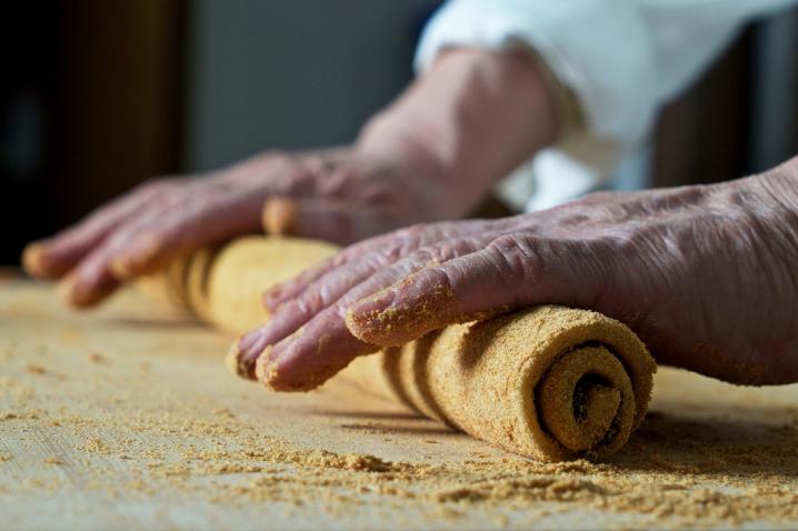 Close-up of hands working a dough.